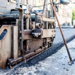 close-up of asphalting machinery and tools working at industrial
